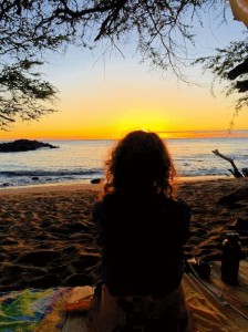 Dr. Connie Hernandez meditates on the beach in Hawaii